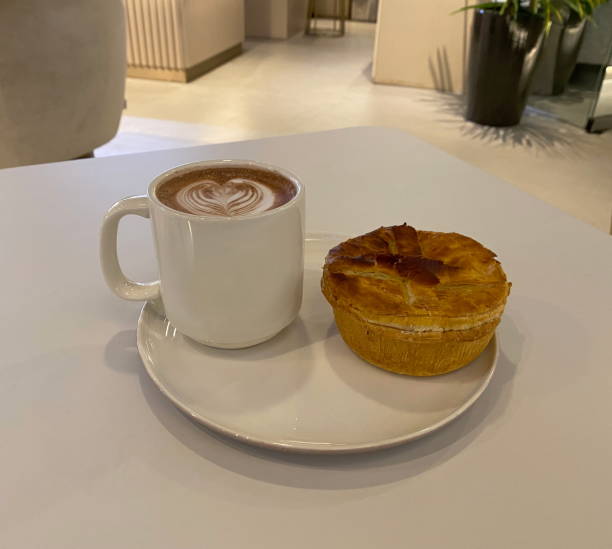 istock Chicken Mushroom Pie and Hot Chocolate with Latte Art in a Cafe 1401478764