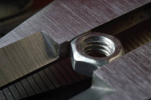 istock Accurate measuring tool caliper and metal ruler lie in place with nuts. close-up 1401478803