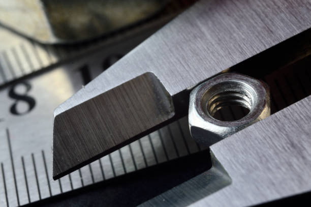 istock Accurate measuring tool caliper and metal ruler lie in place with nuts. close-up 1401478826