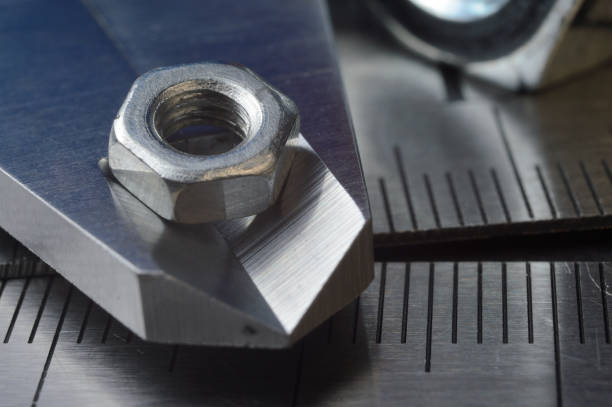 istock Accurate measuring tool caliper and metal ruler lie in place with nuts. close-up 1401478836