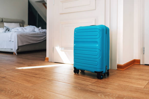 istock Blue travel suitcase in hotel apartment 1401480732