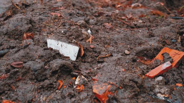 istock Muddy Ground Road with Rain Water Puddles Low Angle Push Forward 1401480984