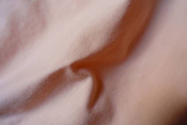 istock pale melon pink cotton jersey fabric in soft folds 1401483228