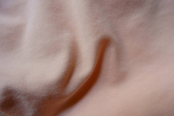 istock Rumpled pale melon pink cotton jersey fabric 1401483232