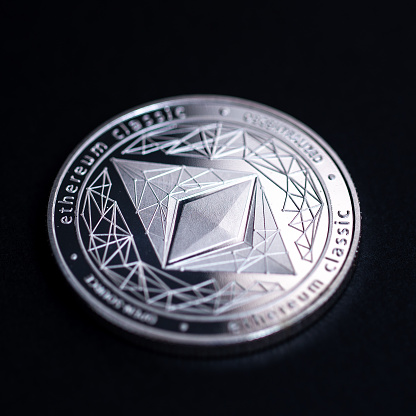 Moscow, Russia - September 08, 2021: Studio shot of silver coin with Ethereum symbol isolated on black background