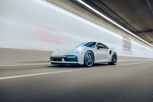 Tacoma, WA, USA\n5/12/2022\nPorsche 911 Turbo S driving in a tunnel with lights on