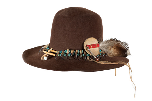 Old Native American hat with hat band made of raptor claws and turquoise on brown felt with eagle feather