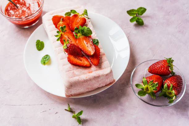 Italian desert Semifreddo with strawberry. Top view Italian desert Semifreddo with strawberry on plate with fresh fruits, mint leaves and dip. Hight angle view Frozen Yogurt stock pictures, royalty-free photos & images