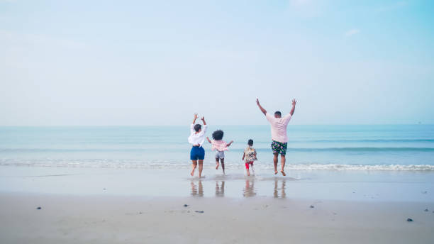 istock Family having fun playing together on the beach. 1401490015