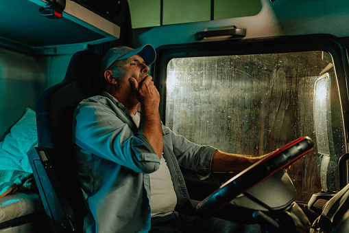 Tired truck driver yawning
