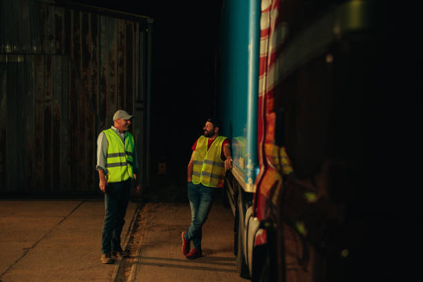 istock Two truckers talking next to a truck 1401494199