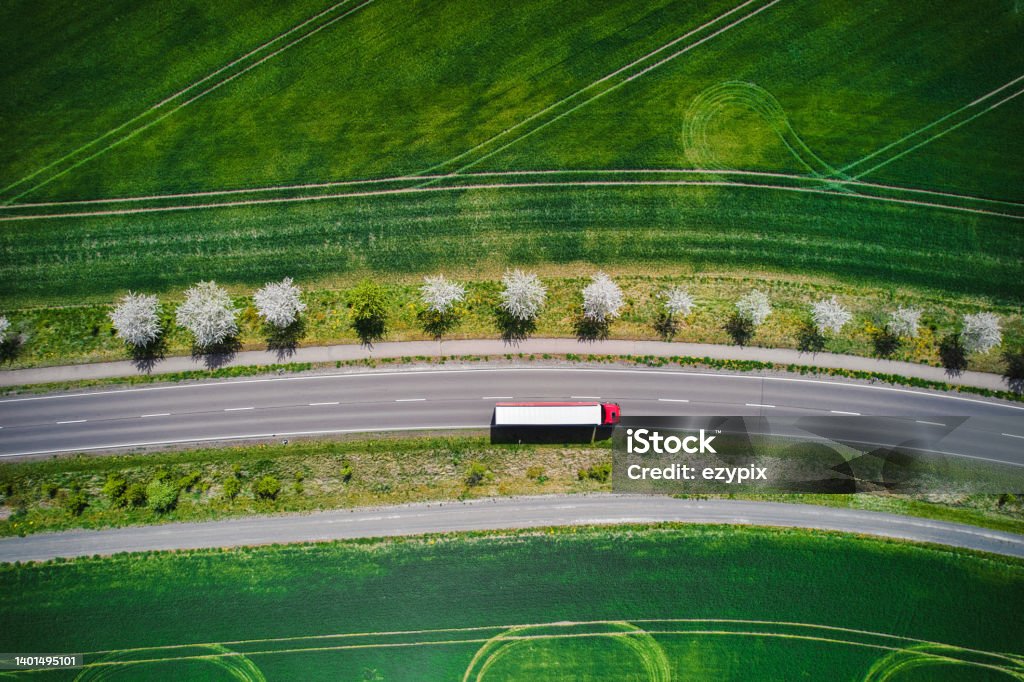 Transportation / Drone / Truck Drone shot direct above a truck moves along a single road. Truck Stock Photo