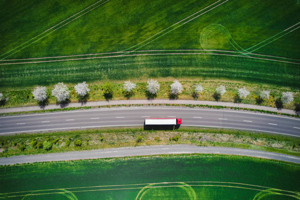 Transportation / Drone / Truck Drone shot direct above a truck moves along a single road. truck stock pictures, royalty-free photos & images