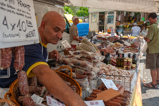 Cannobio, Italy - August 09, 2018: Market stall at the weekly market of Cannobio with Italian salami specialties. Cannobio is a town on Lake Maggiore in the Piedmont region of northern Italy