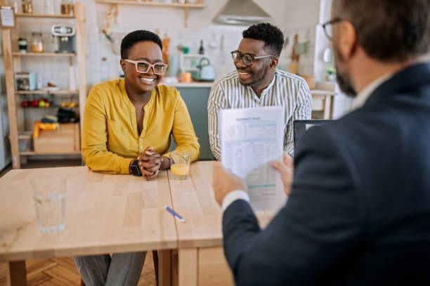 istock Happy couple talking with sales manager 1401497372
