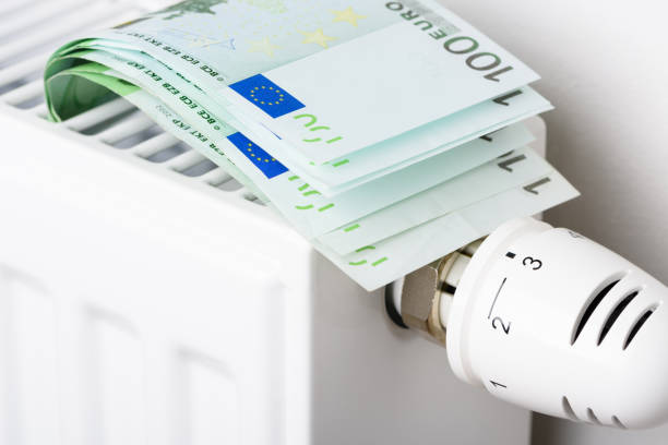istock 100 euro banknotes in heating radiator battery with thermostat temperature regulator 1401499418