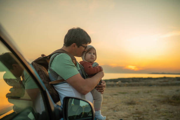 istock Father and daughter enjoying sunset on the beach 1401501976