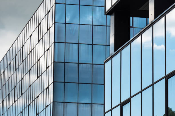 istock Modern Building Glass Facade Reflecting Cloudy Blue Sky 1401502616