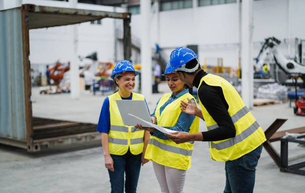 istock Multiethnic engineers working inside robotic factory - Industrial and technology concept - Focus on african man hat 1401502672