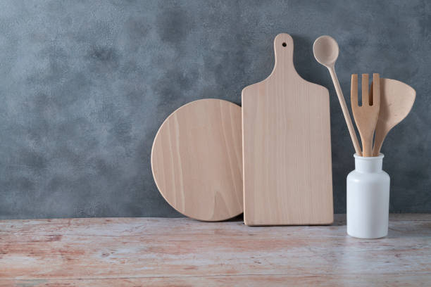 istock Modern kitchen kitchenware in light wood color with ladle, cutting boards and cookware on gray 1401502702