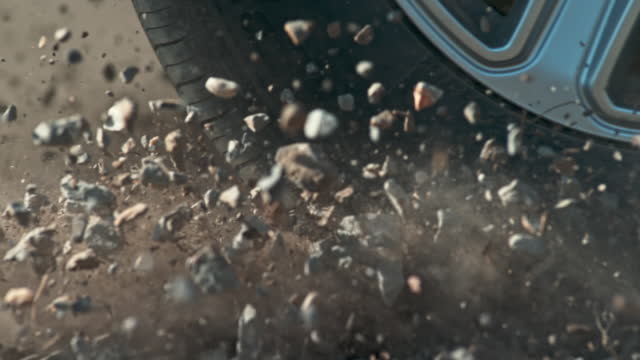 SLO MO Gravel flying in the air as the car breaks hard
