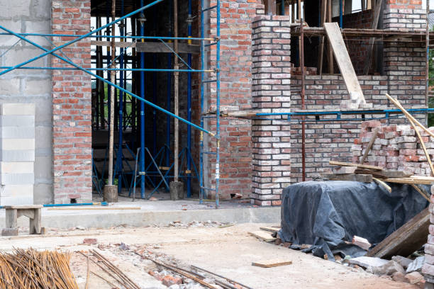 istock Building under construction, industrial background. Construction site with scaffolding. 1401502990