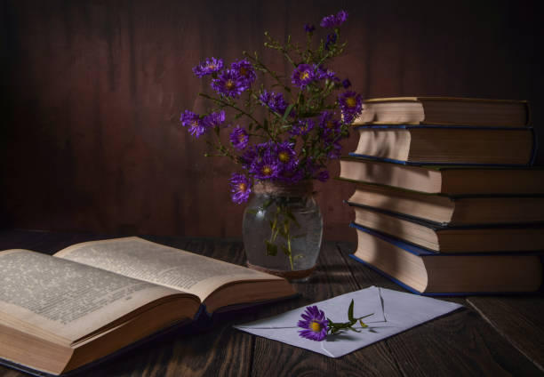 istock Books, flowers, letter on a wooden textured old surface 1401503101