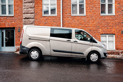 Generic gray van for delivery and small business services standing on the city street in Turku, Finland.