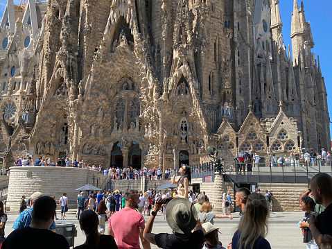Barcelona, Spain, - May 22, 2022.Tourists photographing the Segrada Famila in the city of Barcelona.