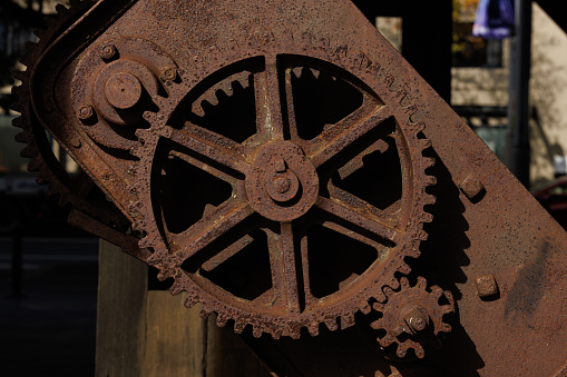 Metal cog in part of an old pulley system