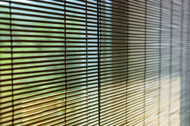 istock Straw window blinds close-up with differential focus. 1401507408