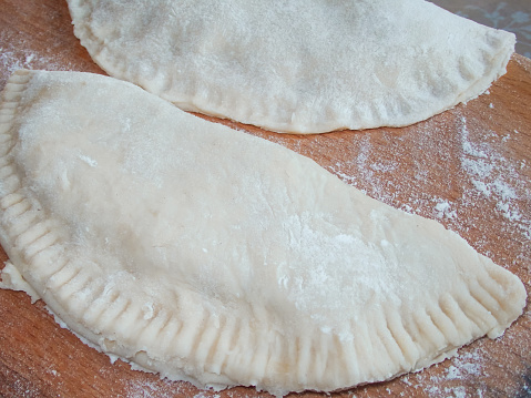 Cooking. Cooking chebureks. Raw meat in dough. A national dish. Cheburek - fried pie with meat and onions. Traditional dish of Turkish and mongolian,pasties empanada