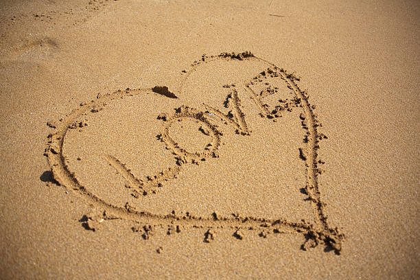 istock Heart shape with love in the sand 140150964