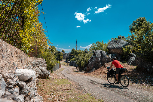 Curvy country road open air with bicyclists on the road,cyclist in red shirt.