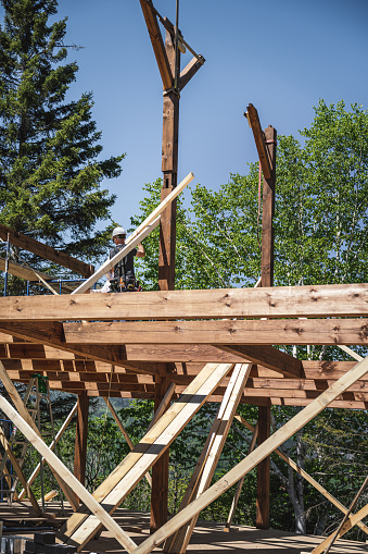 Men building and eco house, Quebec, Canada