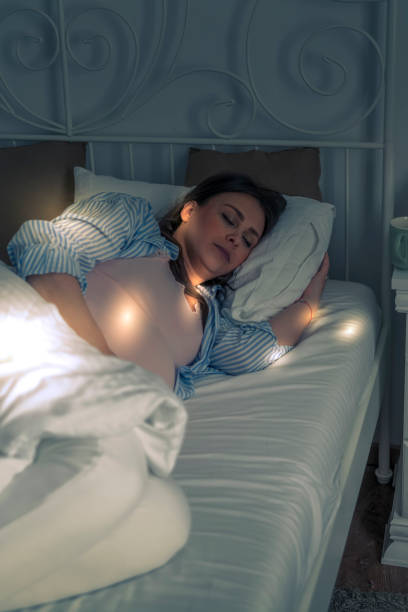 istock Pregnant woman sleeping in her bed 1401515807