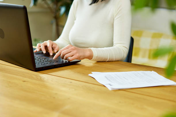 istock Unrecognizable hand Freelancer woman working with laptop on the table at home 1401515879
