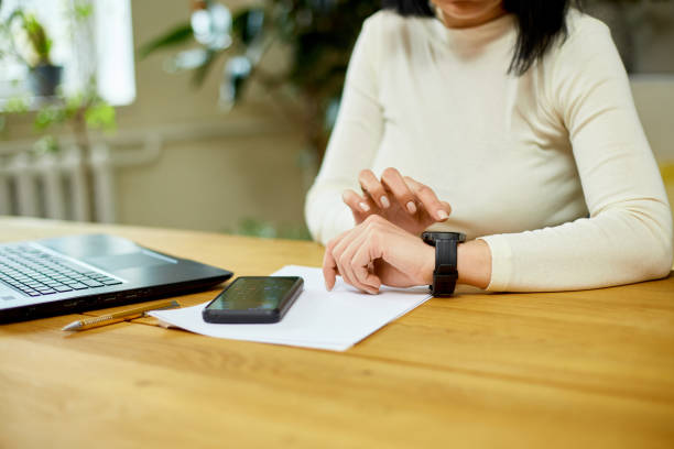 istock Unrecognizable woman using smartwatch, Freelancer female with smart watch 1401515936
