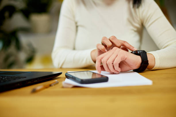 istock Unrecognizable woman using smartwatch, Freelancer female with smart watch 1401515941