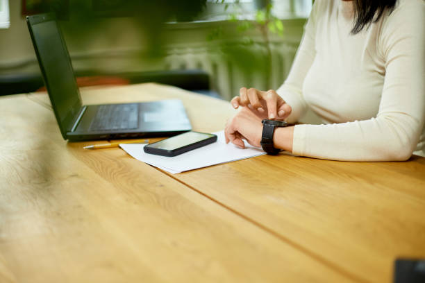 istock Unrecognizable woman using smartwatch, Freelancer female with smart watch 1401515942