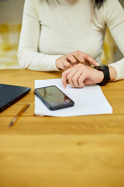 istock Unrecognizable woman using smartwatch, Freelancer female with smart watch 1401515947