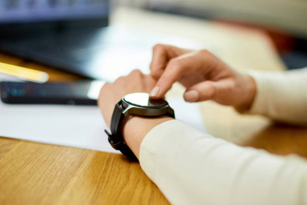Unrecognizable woman using smartwatch, Freelancer female with smart watch