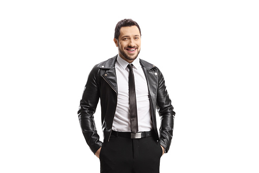 Smiling man in a leather jacket and tie posing isolated on white background