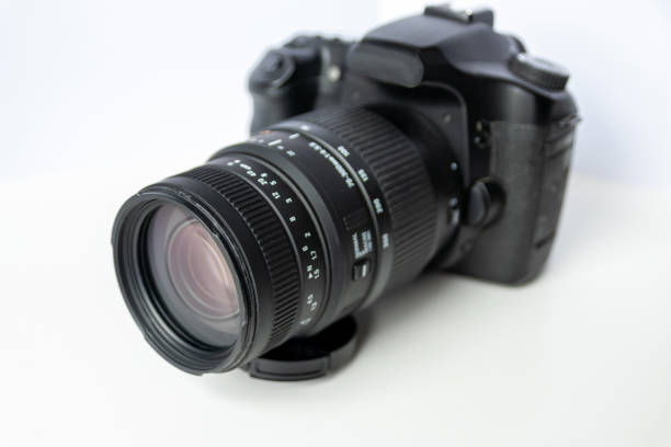 istock Professional dslr camera equipment with 70-300 mm tele zoom objective with wide camera lens in macro close-up view shows details of photographic equipment for studio shots and portrait wildlife photos 1401521097