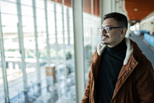 istock Young man contemplating in an airport 1401521371