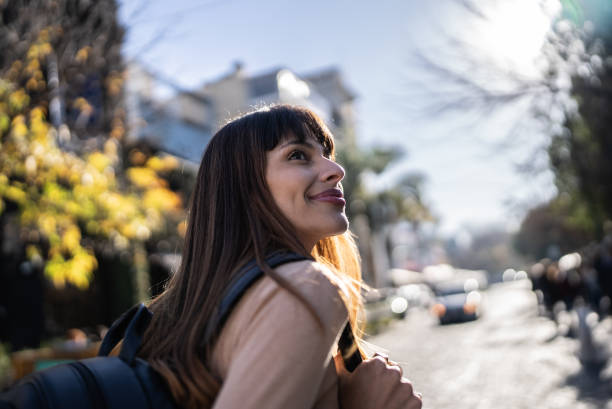 istock Happy young woman exploring city 1401521474
