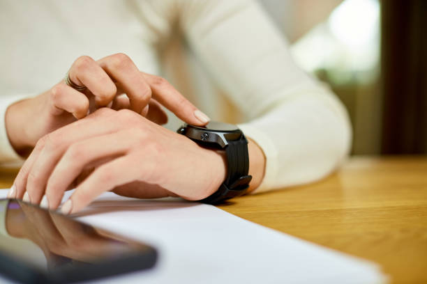 Unrecognizable woman using smartwatch, Freelancer female with smart watch
