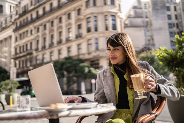 istock Young woman using laptop working in a restaurant 1401521615