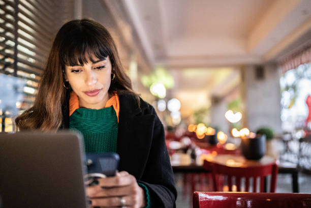 istock Businesswoman working using smartphone in a restaurant 1401522625