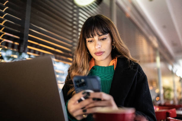 istock Businesswoman working using smartphone in a restaurant 1401522633